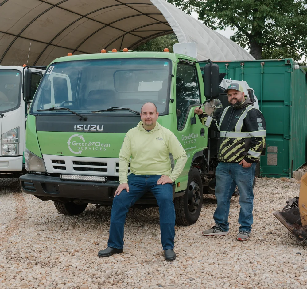 Green and Clean Services parking lot sweeping crew standing with the full sweeper truck in Greensboro NC